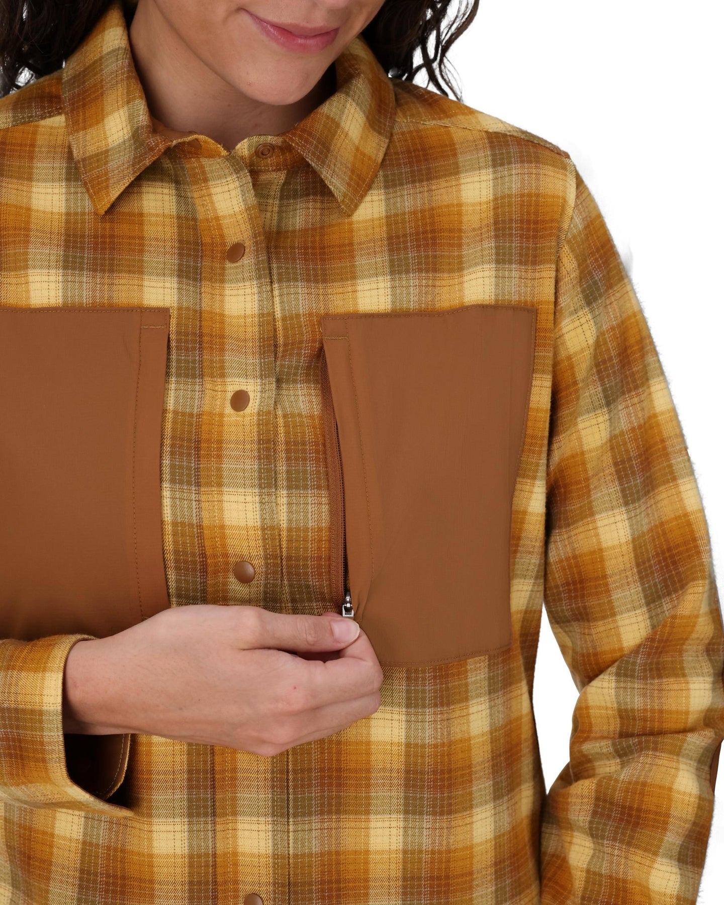Person wearing a plaid shirt with brown patch pockets on a white background