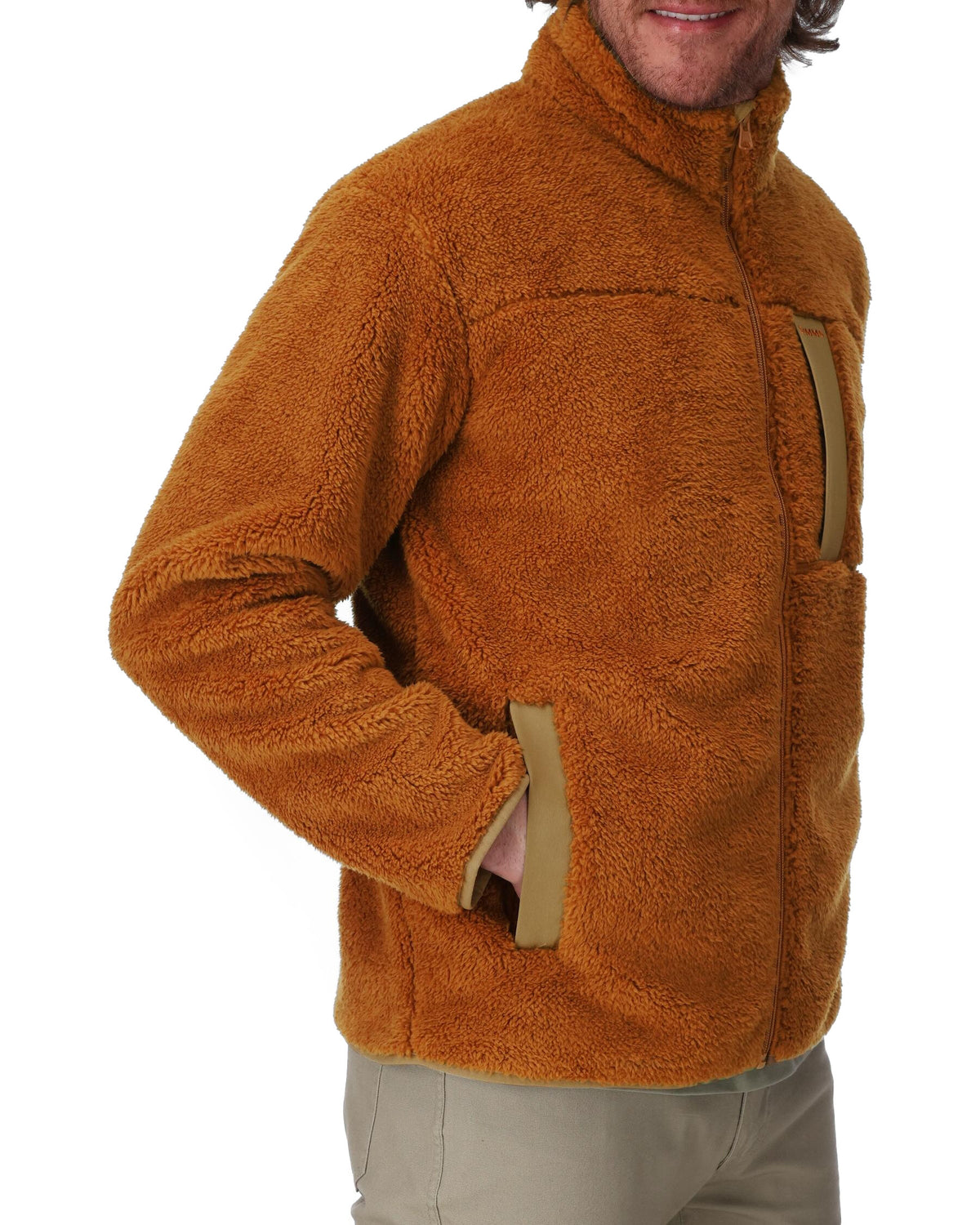 Brown fleece jacket worn by a person on a white background. 