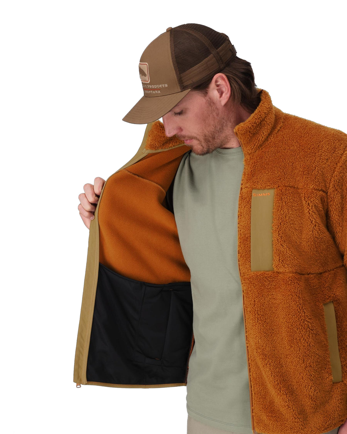 Man wearing a brown jacket with a black interior, standing against a white background. 