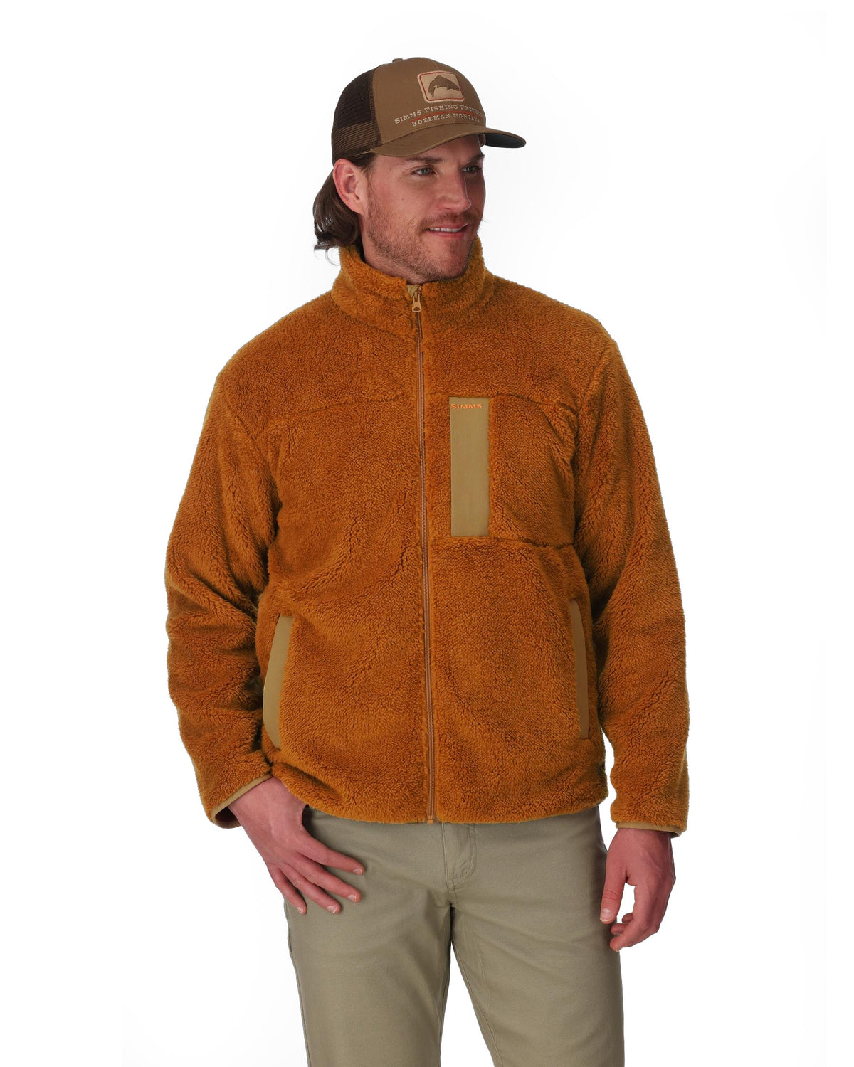 Man wearing a brown fleece jacket and cap on a white background. 